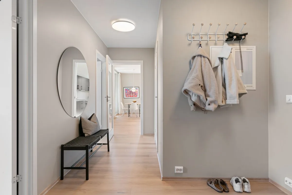 Entrée maison bien rangée avec étagère à chaussures, patères et rangement cartable rentrée
